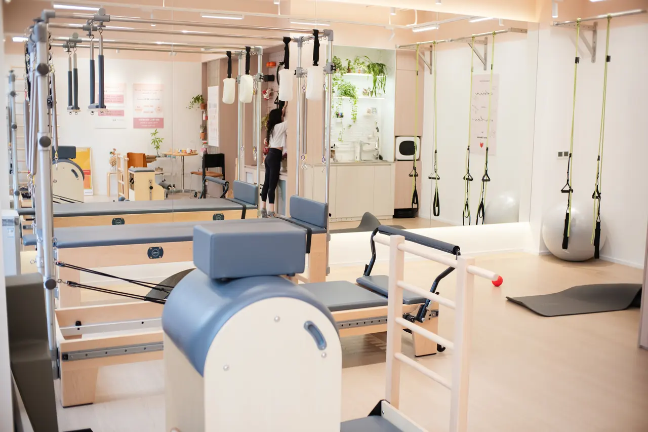 The complete Avec Pilates apparatus room reflected in a wall mirror